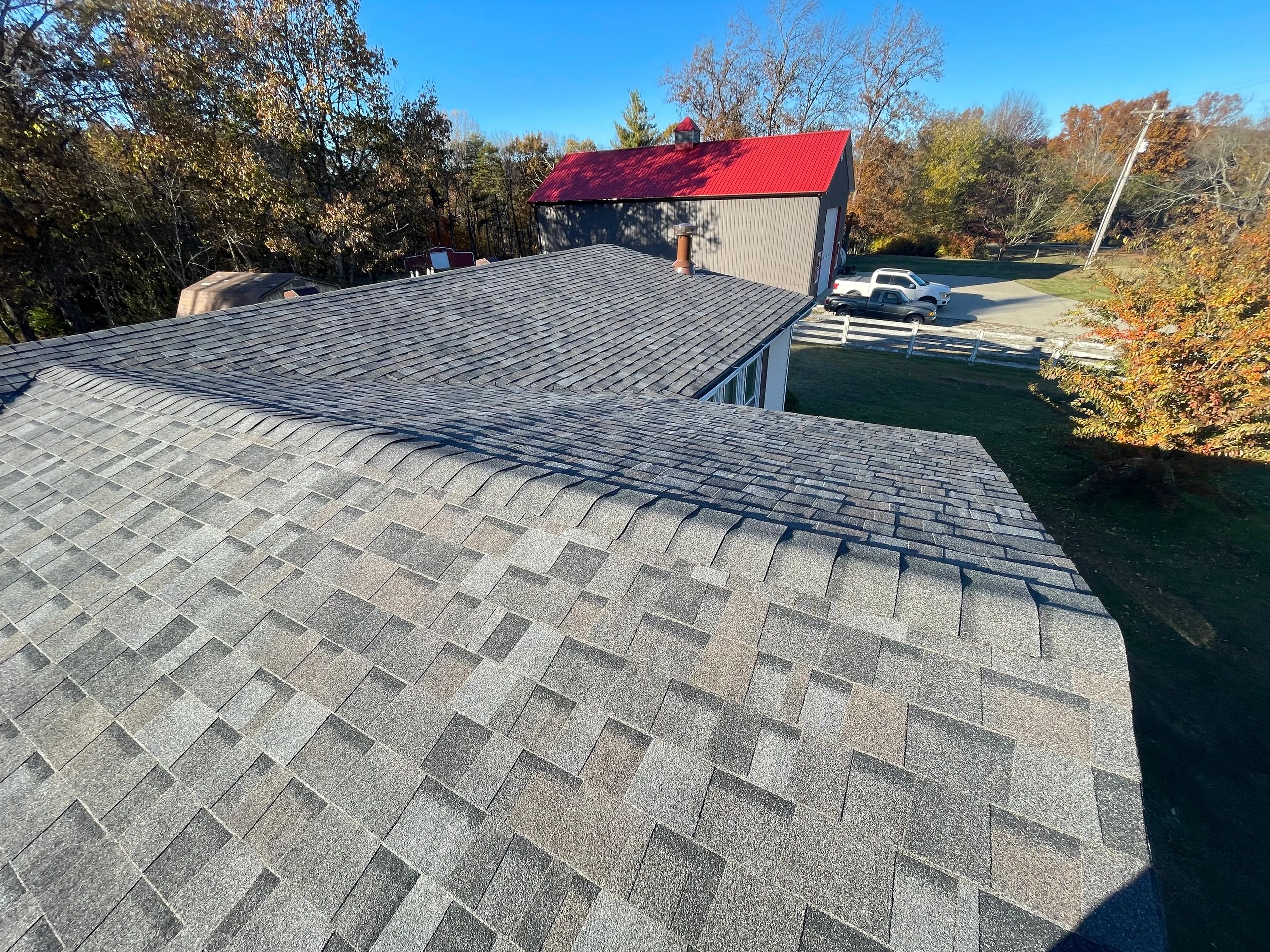 Aerial view of newly installed gray asphalt shingle roof